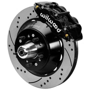 Wilwood black front caliper beside the assembled 14.00-inch drilled and slotted rotor for the Ford/Mercury factory disc-spindle brake conversion, with the hub and wheel studs visible