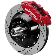 Wilwood red front caliper beside the assembled 14.00-inch drilled and slotted rotor for the Ford/Mercury factory disc-spindle brake conversion, with the hub and wheel studs visible