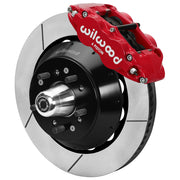 Wilwood red front caliper beside the assembled 14.00-inch slotted rotor for the Ford/Mercury factory disc-spindle brake conversion, with the hub and wheel studs visible