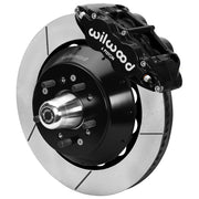 Wilwood black front caliper beside the assembled 14.00-inch slotted rotor for the Ford/Mercury factory disc-spindle brake conversion, with the hub and wheel studs visible