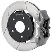 Wilwood gray anodized DPC56 rear caliper beside a vented rotor with machined face grooves and black hat for Corvette C5 and base C6