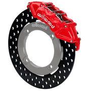 Wilwood red front caliper beside the assembled 11.25-inch drilled rotor for the Honda Talon UTV6 brake conversion