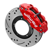 Wilwood red front caliper beside the assembled 11.10-inch drilled and slotted rotor for the 1969–1983 Porsche 911 rotor-and-caliper brake conversion