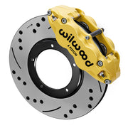 Wilwood yellow front caliper beside the assembled 11.10-inch drilled and slotted rotor for the 1969–1983 Porsche 911 rotor-and-caliper brake conversion