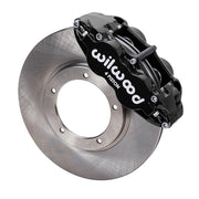 Wilwood front FNSL4R brake kit for Porsche 911 Carrera 24 mm configuration: Black FNSL4R caliper positioned over a plain-faced rotor, with the central opening and five rotor-mount holes visible.