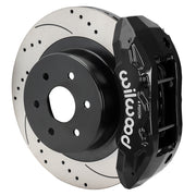 Wilwood rear TX4R brake kit for GM truck factory parking-brake arrangement: Assembled black TX4R caliper over a drilled and slotted rotor with a black center and large hub opening.