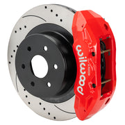 Wilwood rear TX4R brake kit for GM truck factory parking-brake arrangement: Assembled red-finish TX4R caliper over a drilled and slotted rotor with a black center and large hub opening.