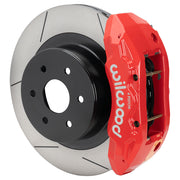 Wilwood rear TX4R brake kit for GM truck factory parking-brake arrangement: Assembled red-finish TX4R caliper over a slotted rotor with a black center and large hub opening.