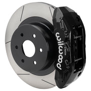 Wilwood rear TX4R brake kit for GM truck factory parking-brake arrangement: Assembled black TX4R caliper over a slotted rotor with a black center and large hub opening.