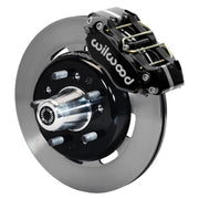 Wilwood front Dynapro brake kit for Tri-Five ProSpindle Dynapro configuration: Assembled plain-faced rotor and black hat with a black Dynapro caliper, projecting hub, five studs and a silver dust cap.