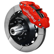 Wilwood front FNSL6R brake kit for Tri-Five ProSpindle 12.88-inch configuration: Assembled slotted rotor and black hat with a red-finish FNSL6R caliper, projecting hub, five studs and a silver dust cap.