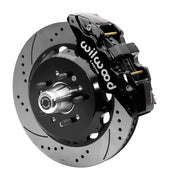 Wilwood front AERO6 brake kit for Tri-Five ProSpindle AERO6 conversion: Assembled drilled and slotted rotor and black hat with a black AERO6 caliper, projecting hub, five studs and a silver dust cap.