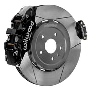 Wilwood rear AERO4 brake kit for Corvette C8 service and parking brakes: Assembled slotted rotor with a black AERO4 caliper and a separate matching parking caliper on the opposite edge.