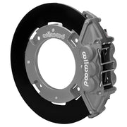 Wilwood rear UTV4 brake kit for Maverick X3 rear race kit: Assembled gray anodized UTV4 caliper over a black solid rotor ring and silver dynamic-mount adapter; the center opening is visible.