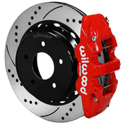 Wilwood red AERO4 rear caliper beside the assembled 14.00-inch drilled and slotted rotor and internal-parking-brake hat for Chevrolet and GMC C1500