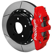 Wilwood red AERO4 rear caliper beside the assembled 14.00-inch slotted rotor and internal-parking-brake hat for Chevrolet and GMC C1500