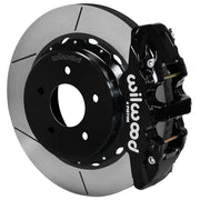 Wilwood black AERO4 rear caliper beside the assembled 14.00-inch slotted rotor and internal-parking-brake hat for Chevrolet and GMC C1500