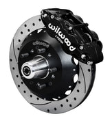 Wilwood black Superlite 6R front caliper beside the assembled 12.88-inch drilled and slotted rotor and hub for Chevrolet full-size drum-spindle