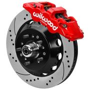 Wilwood red AERO6 front caliper beside the assembled 14.00-inch drilled and slotted rotor and hub for Chevrolet full-size drum-spindle