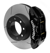 Wilwood black TX6R rear caliper beside the assembled 16.00-inch slotted rotor and hat for Ram 2500 and 3500