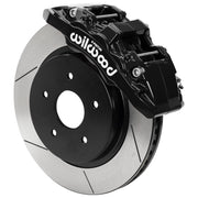 Wilwood black AERODM front caliper beside the assembled 13.38-inch slotted rotor and hat for Ram 1500 2WD