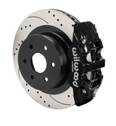 Assembled view of a Wilwood black AERO4 rear caliper with a 14.25-inch drilled and slotted rotor