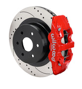 Assembled view of a Wilwood red AERO4 rear caliper with a 14.25-inch drilled and slotted rotor