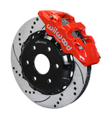 Assembled view of a Wilwood red AERO6 front caliper with a 14.25-inch drilled and slotted rotor