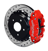 Assembled view of a Wilwood red FNSL4R rear caliper with a 12.88-inch drilled and slotted rotor
