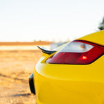 Rennline Carbon Fiber Upkick Spoiler: Elevate your 987 Cayman with this sleek, hand-laid carbon fiber spoiler for an OEM+ look. Shop now at PMB Performance.